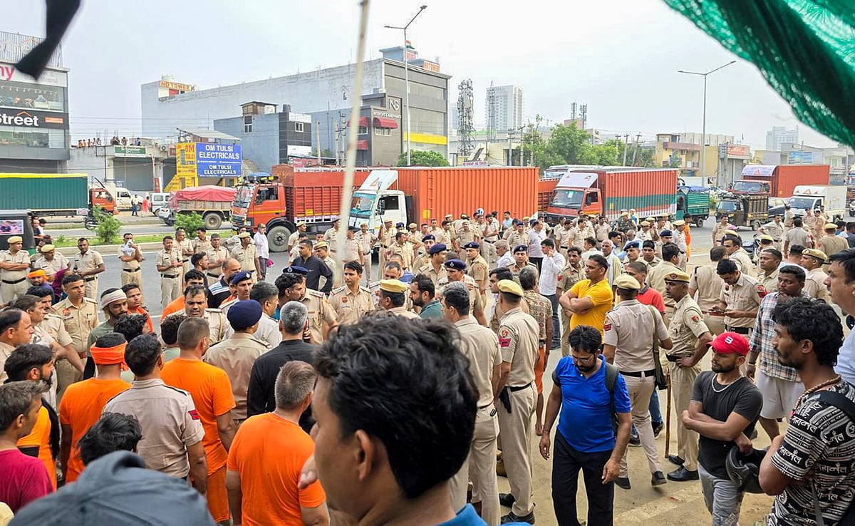 Police personnel conduct investigation after a 17-year-old kanwariya was killed while two of his associates were injured in a collision between their motorcycle and a speeding truck, triggering protests by kanwarias who blocked the Delhi-Jaipur highway, in Gurugram, Wednesday, July 31, 2024 - PTI